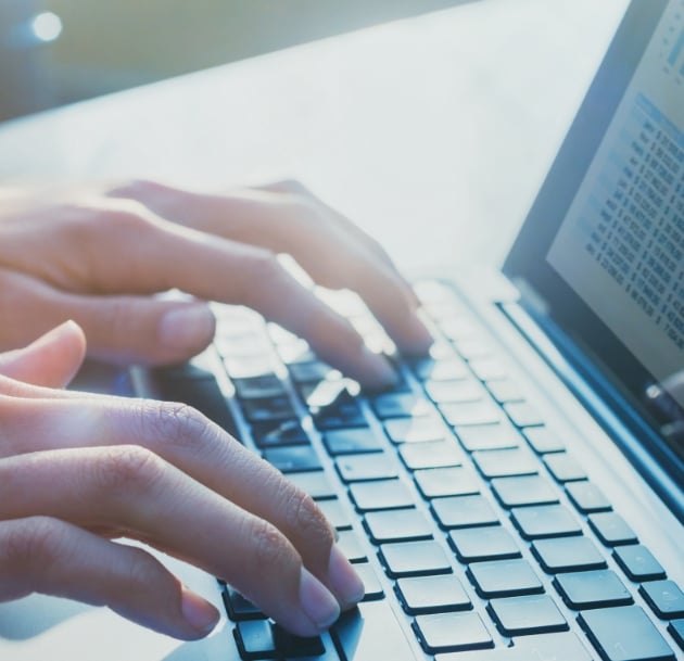 hands typing on keyboard