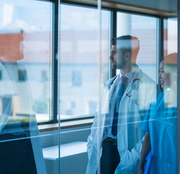 artistic image of transparent doctors standing in front of window