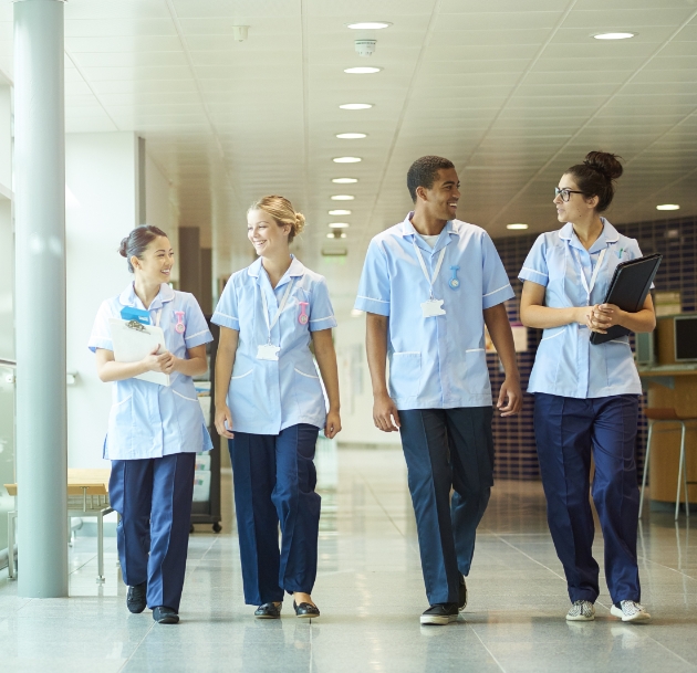 image of medical workers walking in a hall